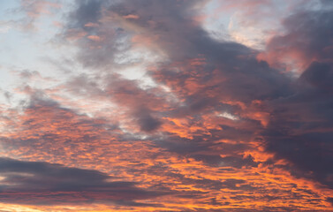 Purple sunset sky clouds with majestic orange sunlight twilight in evening, majestic ​sky vertical.