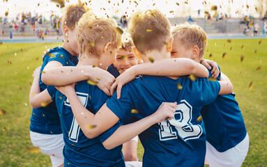 Male school soccer team celebrating success