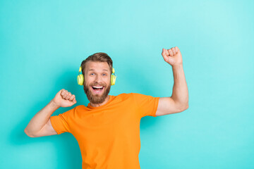 Photo of hooray beard guy listen music dance wear headphones orange t-shirt isolated on teal color backgroiund