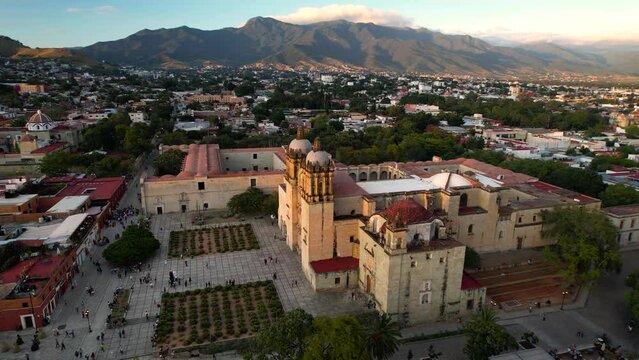 orbital drone shot of santo domingo temple in downtown oaxaca city in mexico during sunset