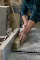 Close up picture of males hands working with a piece of wood