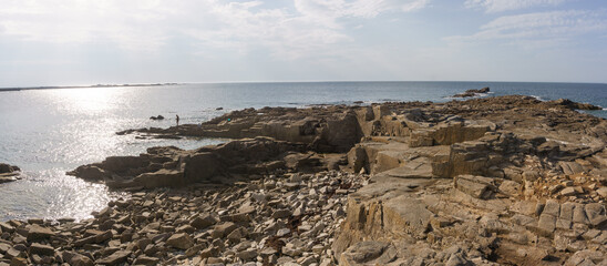 Panorama of bizarre sharp rock formation at Pointe de Castel Erek with fisherman at the Cote de...