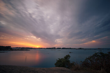 Long exposure of evening sky with clouds of bay of Ploumanac'h during sunset on a summer evening with islands, Cote de Granit Rose Brittany , France