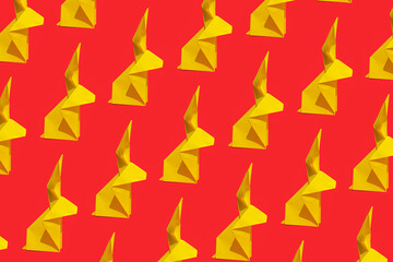 Creative seamless printable pattern design made of yellow paper rabbit on a vibrant red background. Lunar, Chinese New Year greeting cad for 2023. Year of the Rabbit.