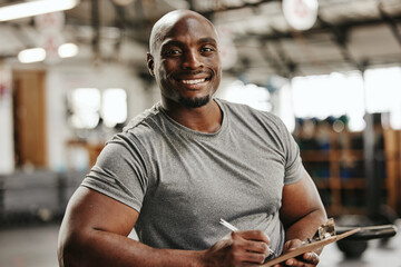 Gym, documents or black man writing on clipboard for membership, sign up or checklist for sport health or workout. Wellness coach, fitness or happy personal trainer, paper for exercise schedule - Powered by Adobe