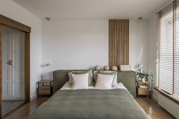 Fototapeta na wymiar Modern Japandi bedroom interior design in earth tones, natural textures with wooden solid oak furniture. Japandi concept