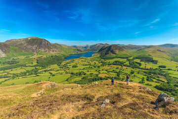 Fototapeta premium Fell walkers admiring the view in Cumbria