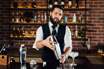 barman preparing cocktail using shaker