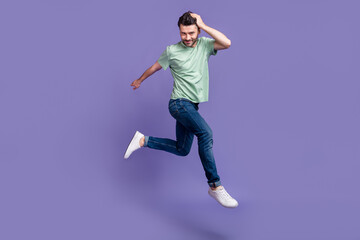 Fototapeta na wymiar Full length photo of cheerful attractive virile man enjoy new hairdo dressed trendy clothes isolated on purple color background