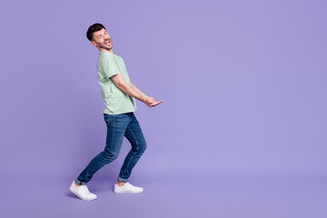 Fototapeta na wymiar Full body photo of attractive man carry empty space invisible heavy box dressed stylish gray garment isolated on purple color background