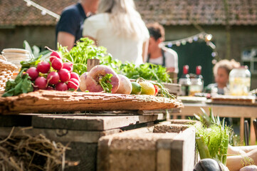 BBQ Outdoor with food preparations. People eating and dining outdoor. Lots of vegetables, fish, and meat.