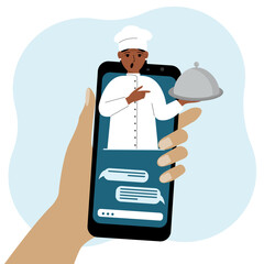 Online food shopping on mobile phone or fast food delivery order. The cook holds a tray with a lid or a plate with a cloche.