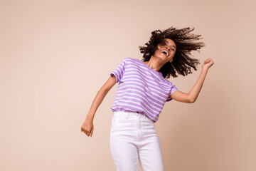 Photo of pretty funky lady wear violet t-shirt having fun dancing empty space isolated beige color background