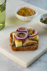 Smorrebrod - traditional Danish sandwiches. Black rye bread with salmon, cream cheese, capers. Side view, close up