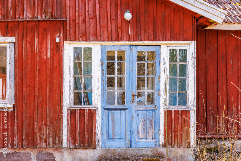 Canvas Prints Weathered old red cottage on a sunny day