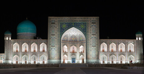 Registan Square at night. Samarkand. Uzbekistan. the inscription above the gate in a special Arabic...
