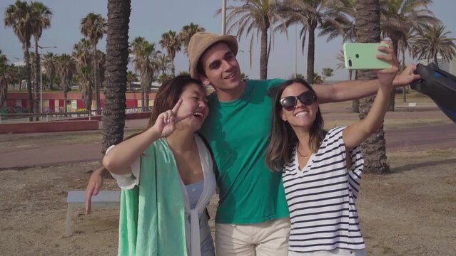 Group of friends taking selfie happy laughing in the beach in summer.