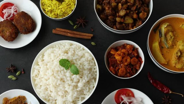 Top view of white rice spicy hot Bengali Prawn roast , shrimp masala fish curry. Indian food. Fish fry beef pork cutlet. Asian cuisine. Kerala, Goan fish curry clay pot. Grilled tiger shrimps