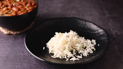 Kidney bean curry or rajma or rajmah chawal and rice roti, typical north Indian food main course. Basmati rice with dal curry.  4k video footage