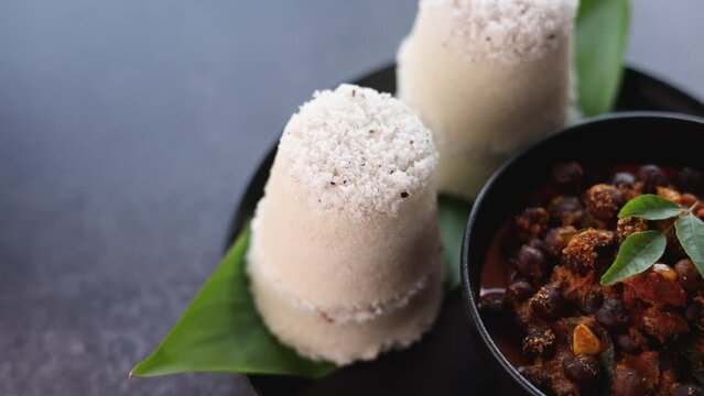 Rice Puttu white Pittu , Kadala Chickpea curry , milk tea , popular South Indian breakfast steamed rice cake Kerala food Tamil Nadu India Sri Lanka. rice flour grated coconut