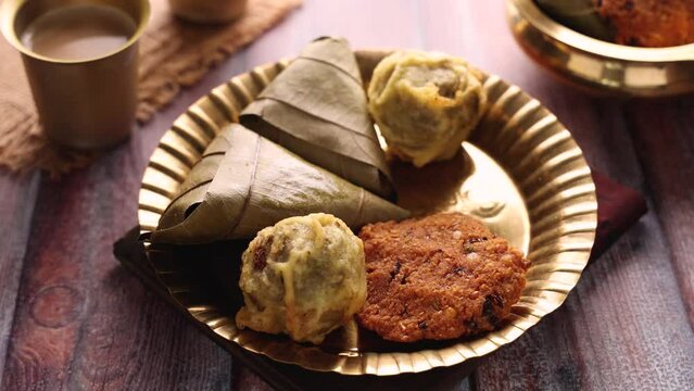 Sukhiyan or Sugiyan Parippu Vada Ila Ada Sweet rice dumplings Elayada steamed rice cakes wrapped in banana leaves famous breakfast or tea snacks of Kerala India.