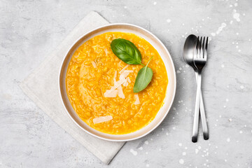 Pumpkin soup or pumpkin risotto with pumpkin seeds, with basil and olive oil. seasonal fall menu