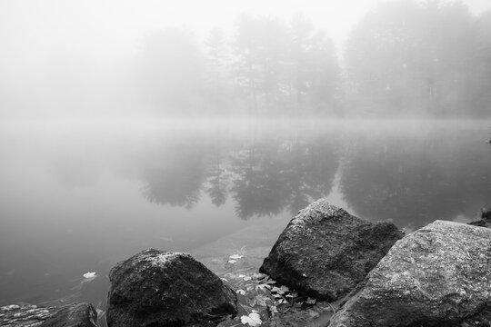 Foggy Pond in Autumn. High quality photo was taken early in the morning on a clear lake in New England
