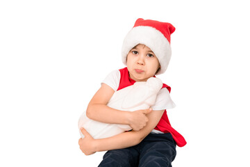 Portrait of unhappy resentful little child in red Santa Claus hat isolated on white background. Beautiful five-year European boy. Bad gift. Copy space. Merry Christmas. Bad mood. Close-up. New Year