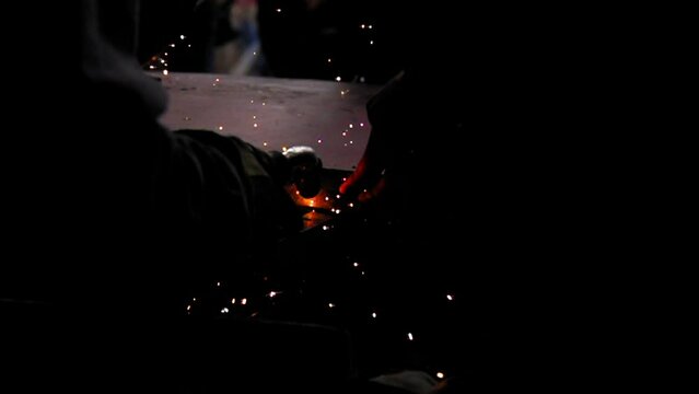 Slow Motion Lockdown Shot Of Welder Using Welding Torch On Metal - Yellowstone Park, Montana