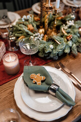 Table setting close-up on Christmas Eve and gifts for family members on plates