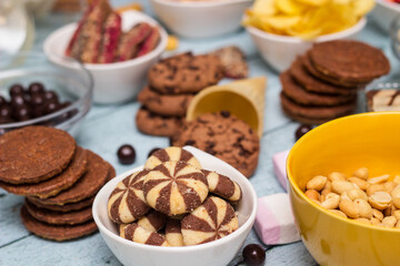 Salty and sweet snacks. Table of salty and sweet snacks. Large group of unhealthy food