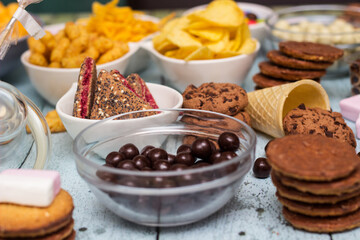 Salty and sweet snacks. Table of salty and sweet snacks. Large group of unhealthy food