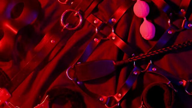 Set of exotic adult sex toys for BDSM sex with submission and domination. Handcuffs, mask, leather whip flogger and female vibrator