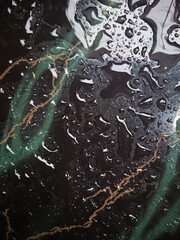 close up background, Rain Water Drop at black abstract tile 
