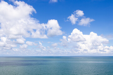 Naklejka na ściany i meble Beautiful calm turquoise color sea and blue sky with white color cloud background