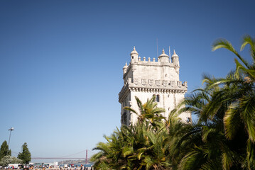 Fototapeta premium Huge decorated tower behind palm tree leafs