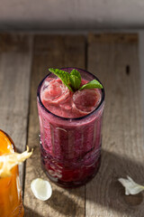 Healthy smoothie fruits with yogurt Blended blackcurrant drink on wooden table
