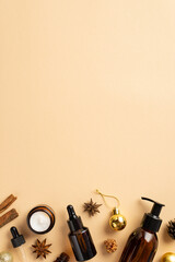 Winter skincare cosmetics concept. Top view vertical photo of glass amber bottles cream jar golden...