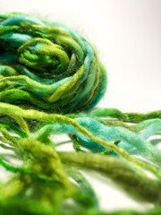 Green hand spun wool yarn on white background