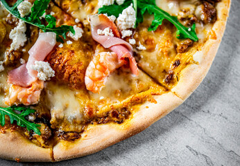 Pizza with Mozzarella cheese, meat, beef, ham, mushroom, shrimp, spices. Italian pizza