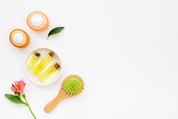 Hair care cosmetic products with brush, top view