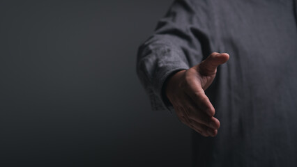 Business people in office suits standing and shaking hands, close-up. Business cooperate teamwork and communication concept. Handshake and marketing.