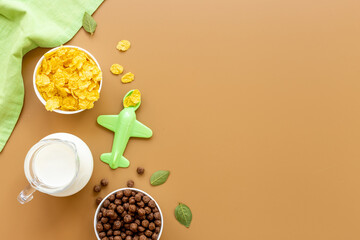 Kids morning with corn flakes milk and orange for breakfast