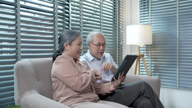 Asian elderly couples spend their free time happily together at home.