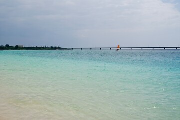 Fototapeta premium The shining sea of Yonaha Beach and the Kurima Bridge