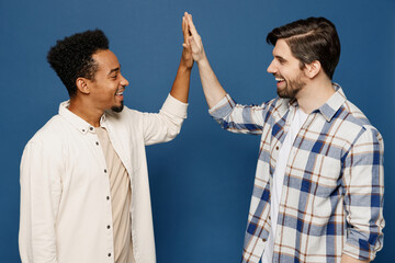 Side view young two friends men wear white casual shirts meet together greeting giving high five...