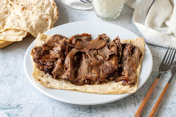 Turkish meat doner on gray background. Traditional flavors. Doner kebab made from beef and lamb. close up