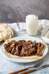 Turkish meat doner on gray background. Traditional flavors. Doner kebab made from beef and lamb. close up
