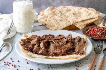 Turkish meat doner on gray background. Traditional flavors. Doner kebab made from beef and lamb. close up