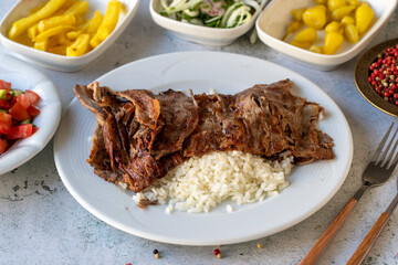 Meat doner with rice on gray background. Traditional flavors. Doner kebab made from beef and lamb....